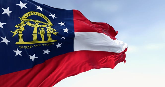 Close-up of Georgia state flag waving in the wind on a clear day. Red, white, red stripes. Blue canton with 13 stars and coat of arms. 3d illustration render. Fluttering textile