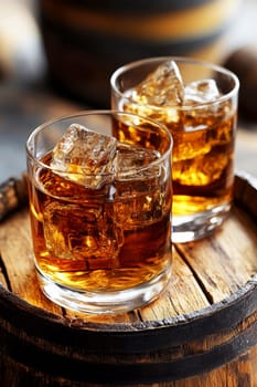 Two elegant, crystal-clear glasses of whiskey with ice cubes. AI generative.
