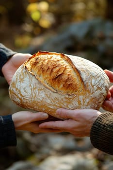 passing a loaf of bread from one hand to another, symbolizing sharing and human ties. AI generative.