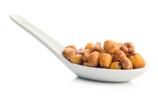 Roasted salted corn snack in ceramic spoon  isolated on a white background.