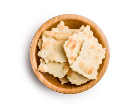 A crispy salted crackers in bowl isolated on a white background.