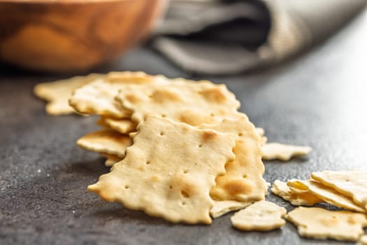 A crispy salted crackers on a black table.