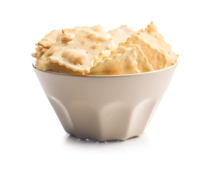 A crispy salted crackers in bowl isolated on a white background.