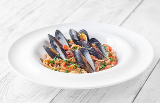 A plate of flavorful mussels and fettuccine pasta