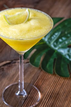 Frozen Banana Daiquiri with lime wedge garnish