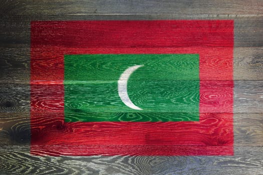 A Maldives flag on rustic old wood surface background