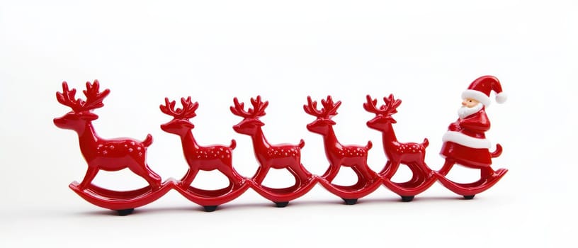 A cheerful Santa figure rides on a sleigh pulled by six red reindeer bringing a festive touch to holiday decorations.