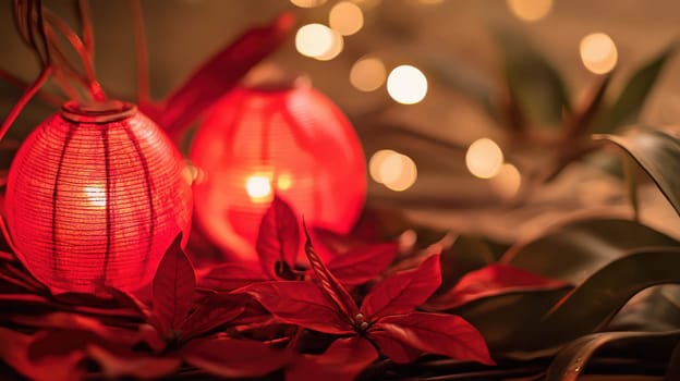 Two glowing red lanterns surrounded by vibrant leaves and soft lights create a warm and inviting atmosphere during the holiday season.
