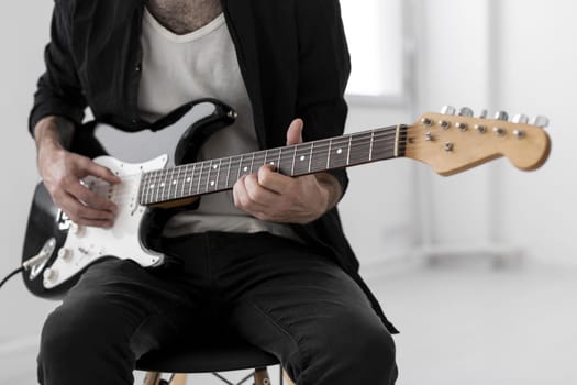 front view male musician playing electric guitar (1)
