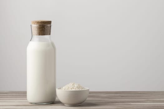 front view milk bottle with rice copy space