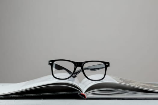 front view open book with glasses