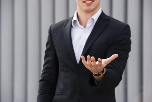 front view businessman holding hand out