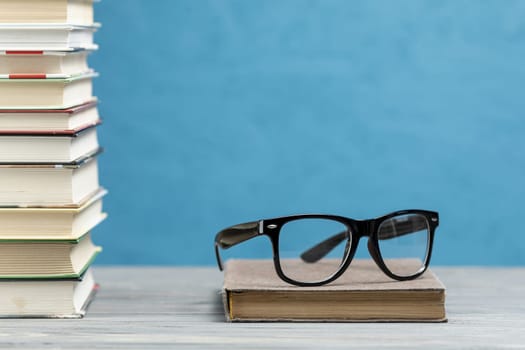 front view pile books with glasses