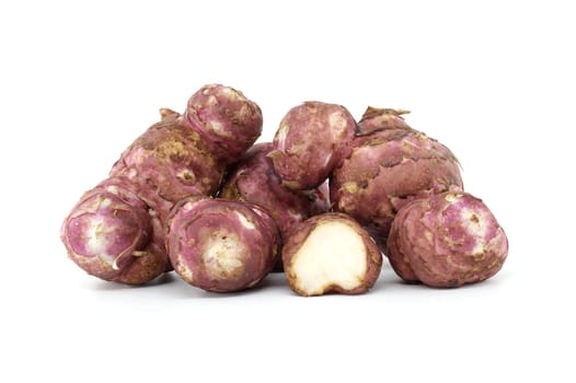 A group of fresh Jerusalem artichokes are shown against a white background, highlighting their texture and natural color. Ideal for food, health, and organic nutrition themes