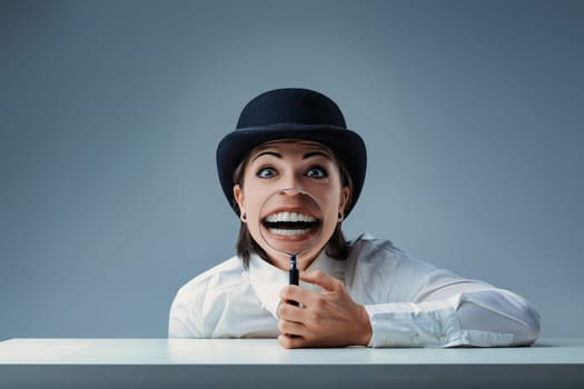 Young businesswoman in a bowler hat smiles with a magnifying glass, creating a comically large grin