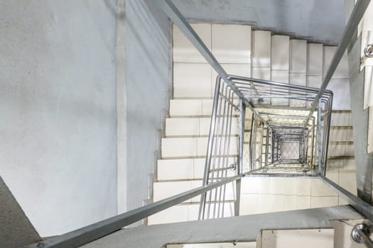 Generic modern square staircase shaft with steel net for fall safety