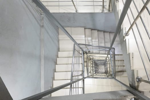 Generic modern square staircase shaft with steel net for fall safety