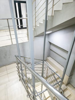 Generic modern staircase with a sleek stainless steel railing and minimalist design elements enhances its visual appeal