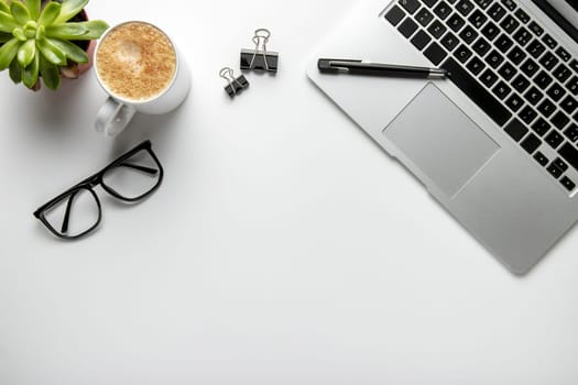 flat lay desk with laptop glasses