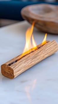 burning stick of Palo Santo.Palo Santo with fire inside on marble surface.rituals and aromatherapy