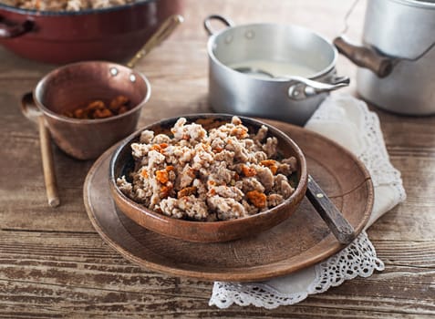 Slovenian traditional dish buckwheat mush served with pan-fried pork cracklings and lard and bowl warm milk