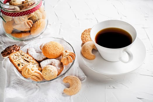 Tasty homemade sugar cookies and biscuits of all shapes and sizes with fresh coffee cup