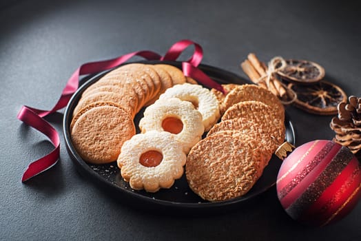 Christmas winter plate with tasty homemade sugar cookies decorated with christmas ornament