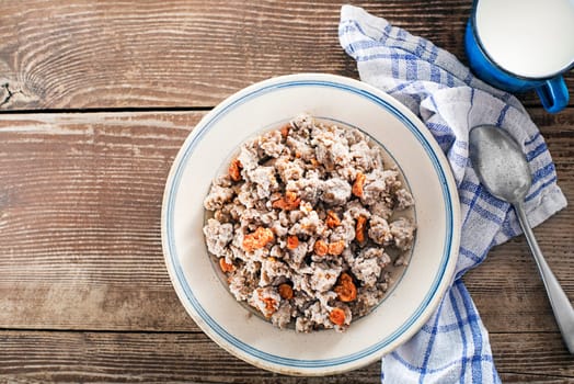 Slovenian traditional dish buckwheat mush served with pan-fried pork cracklings and lard and bowl warm milk