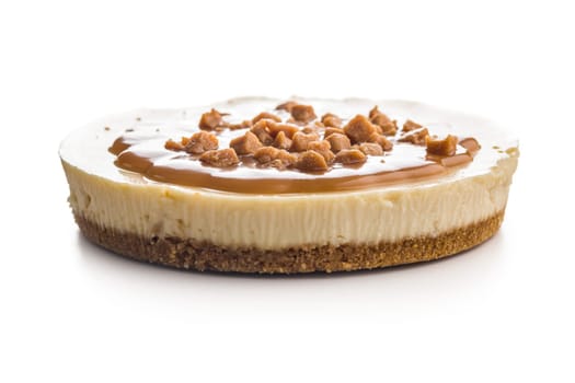 Cheesecake with caramel topping isolated on a white background.