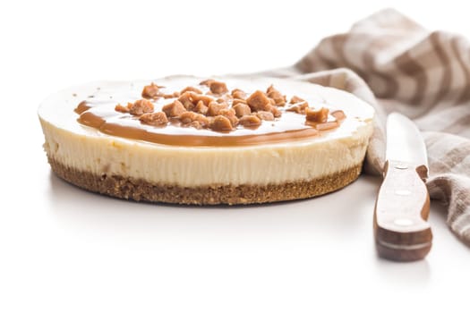Cheesecake with caramel topping isolated on a white background.