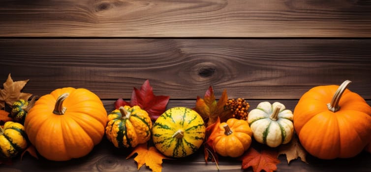 Autumn leaves and pumpkins on wooden background with copyspace - AI generated