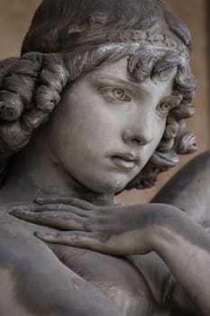 Guardian angel statue in antique cemetery