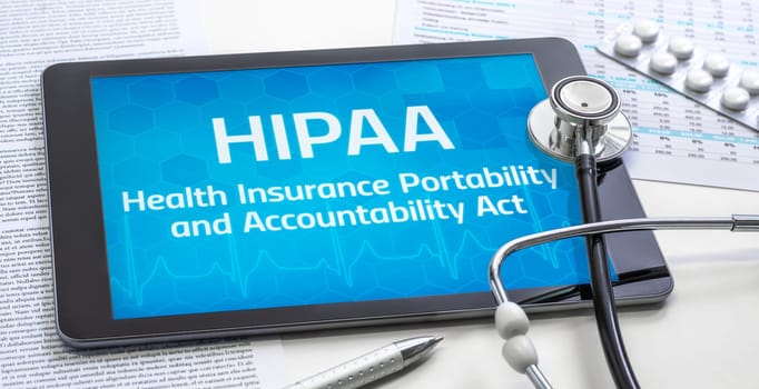 A tablet with the the word HIPAA on the display
