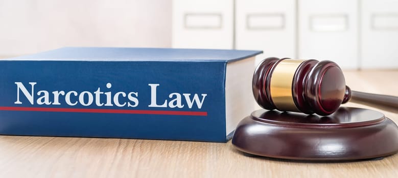 A law book with a gavel  - Narcotics Law