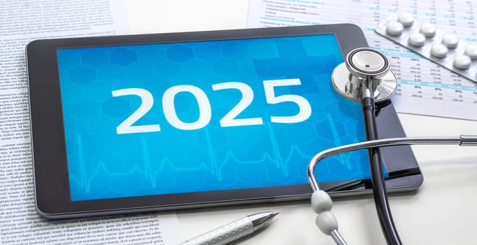 A tablet with the number 2025 on the display
