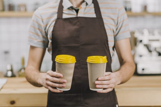 crop barista with hot drinks