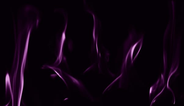Various flames from a fire in purple against a black background