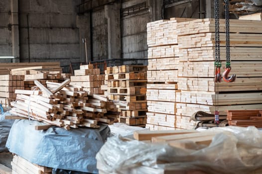 Stacked wooden planks close-up at lumber warehouse. Wood industry concept