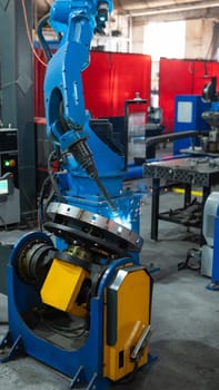 Automatic Industrial welding robot in a modern factory in operation.