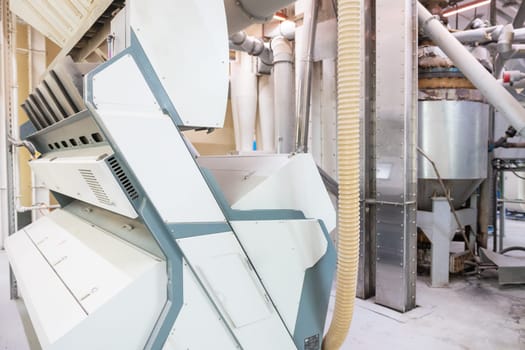 Roller deck machines for husking buckwheat grain, operating in a modern processing facility.