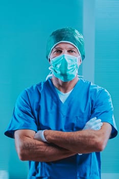 Portrait of a confident surgeon wearing a surgical mask, cap, and gloves, standing with arms crossed in a hospital operating room, conveying professionalism and preparedness