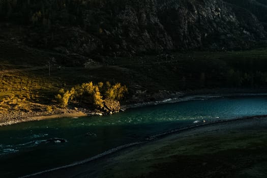 The mountain river flows over the rocks. The rivers are altai. Nature is altai.