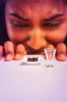 Young woman staring in disgust at a tiny plate of sushi, emphasizing the struggle with microscopic portions and the challenges of dietary restrictions in modern lifestyles
