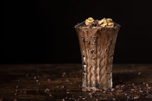 close up view chocolate milkshake with walnuts
