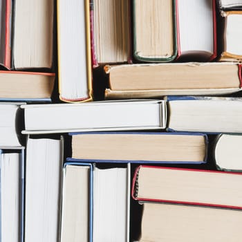close up randomly stacked books
