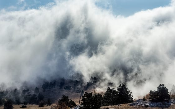 Low clouds over the valley, view from the mountains. Low clouds.