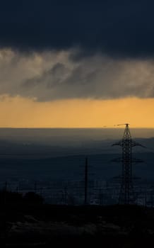 Dawn in the mountains of Crimea. A light haze of mist over the mountains and rays of the sun through the clouds.