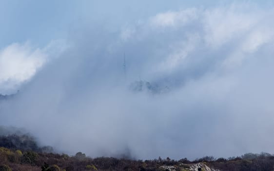 Low clouds over the valley, view from the mountains. Low clouds.