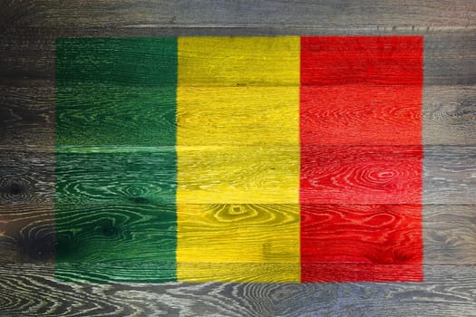 A Mali flag on rustic old wood surface background