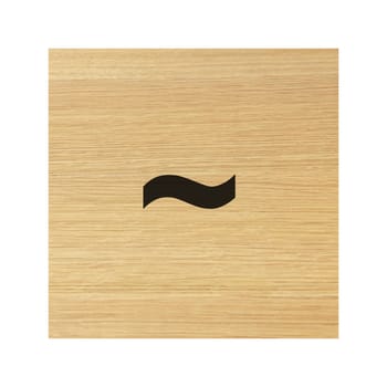 A tilde operator sign on childs wood block on white with clipping path